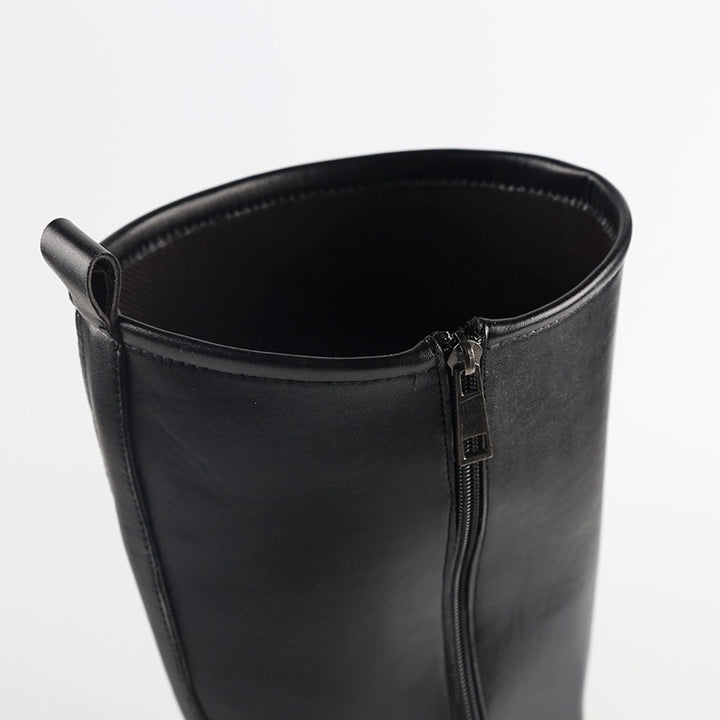 Black rinding boots under the knee